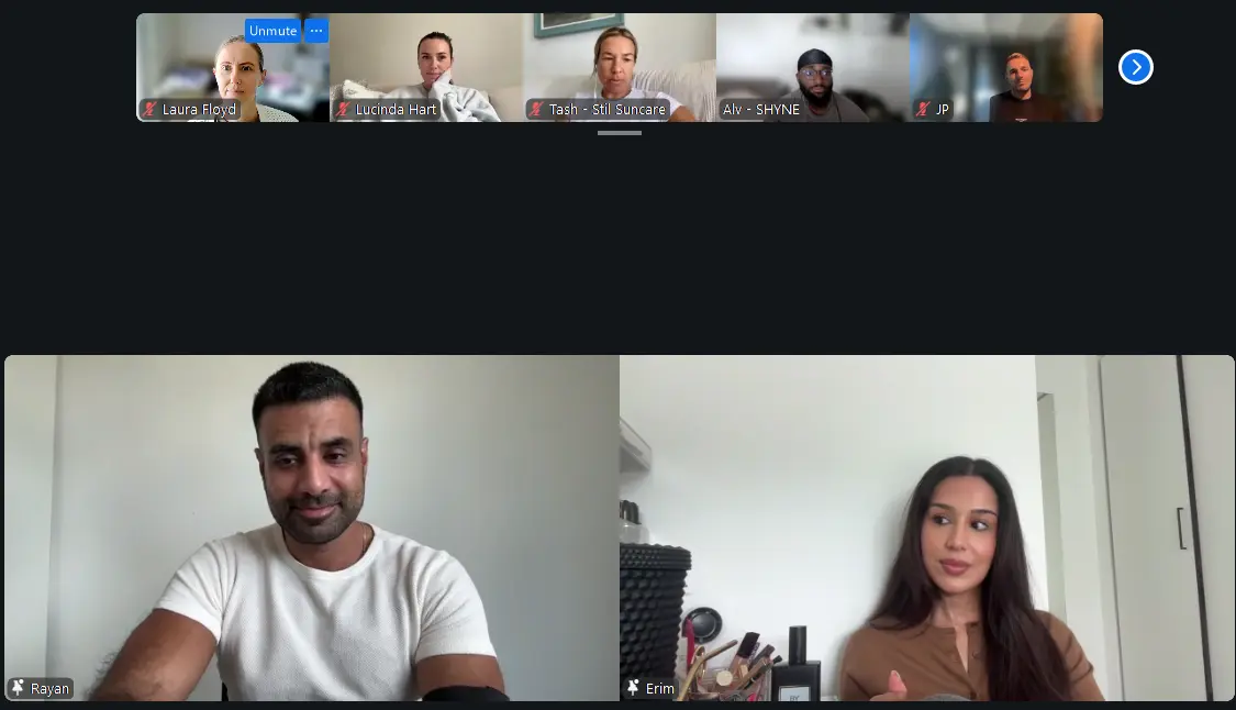 A cohort of founders on a video call, two speakers on screen and others watching